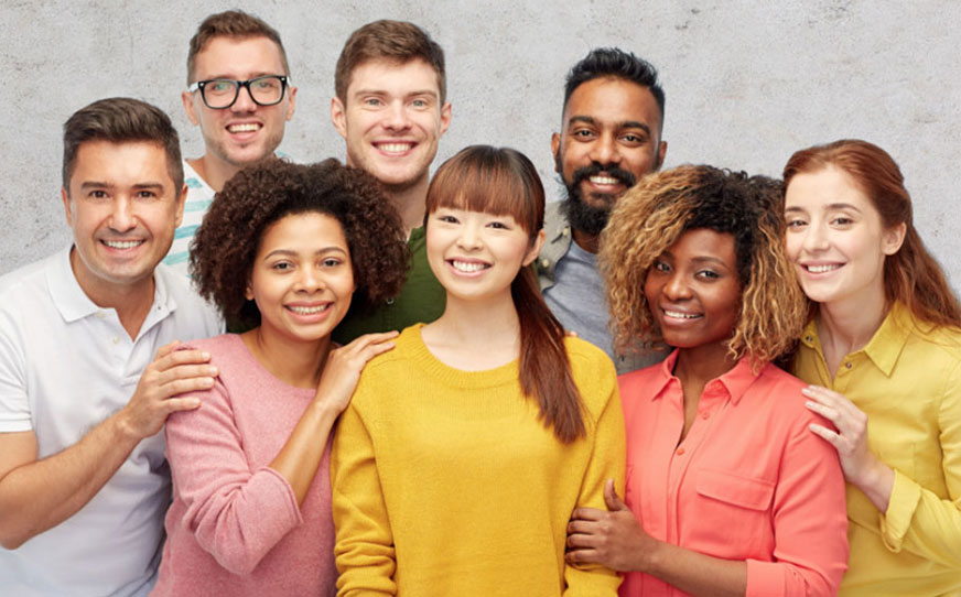 A diverse group of people smiling at the camera in a group photo