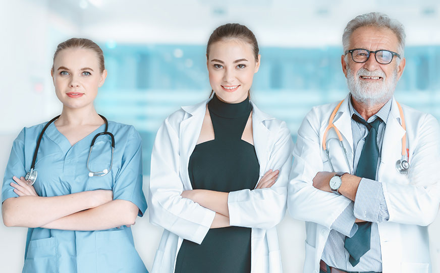 Dermatomyositis, three doctors facing the camera smiling with their arms crossed